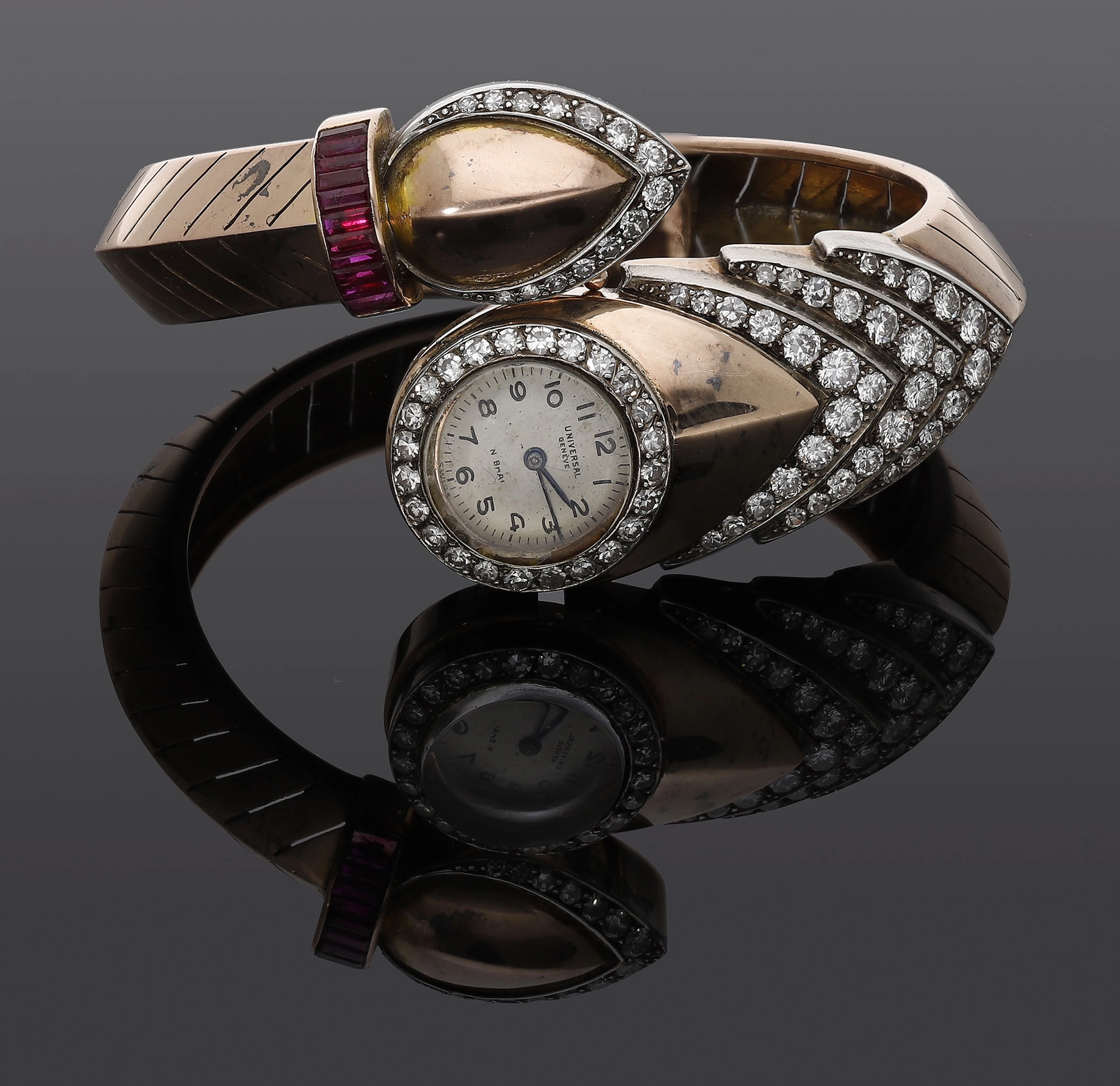 Universal. A lady’s gold, diamond and synthetic ruby-set bangle watch