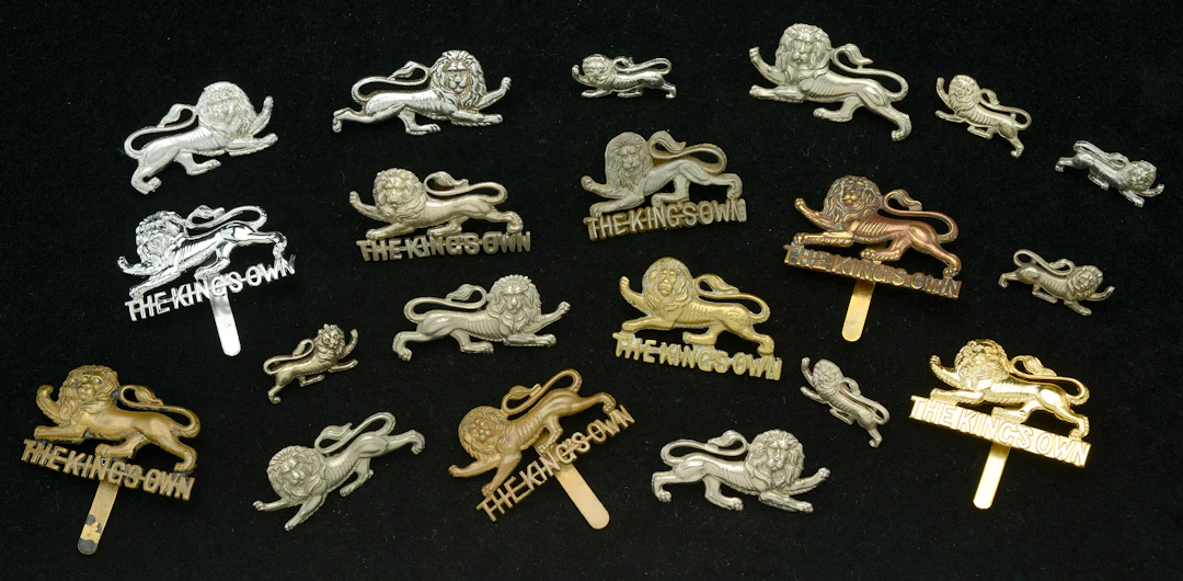 The King’s Own Regiment, assorted Other Ranks Cap and Collar Badges.