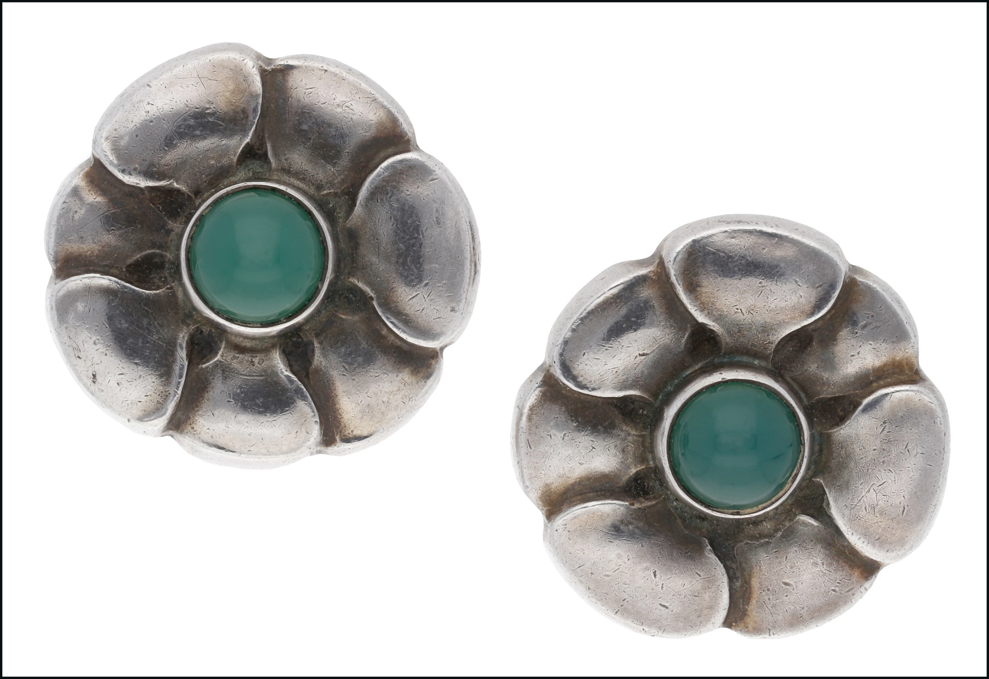 A pair of chrysoprase and silver ear studs by Georg Jensen, of flowerhead