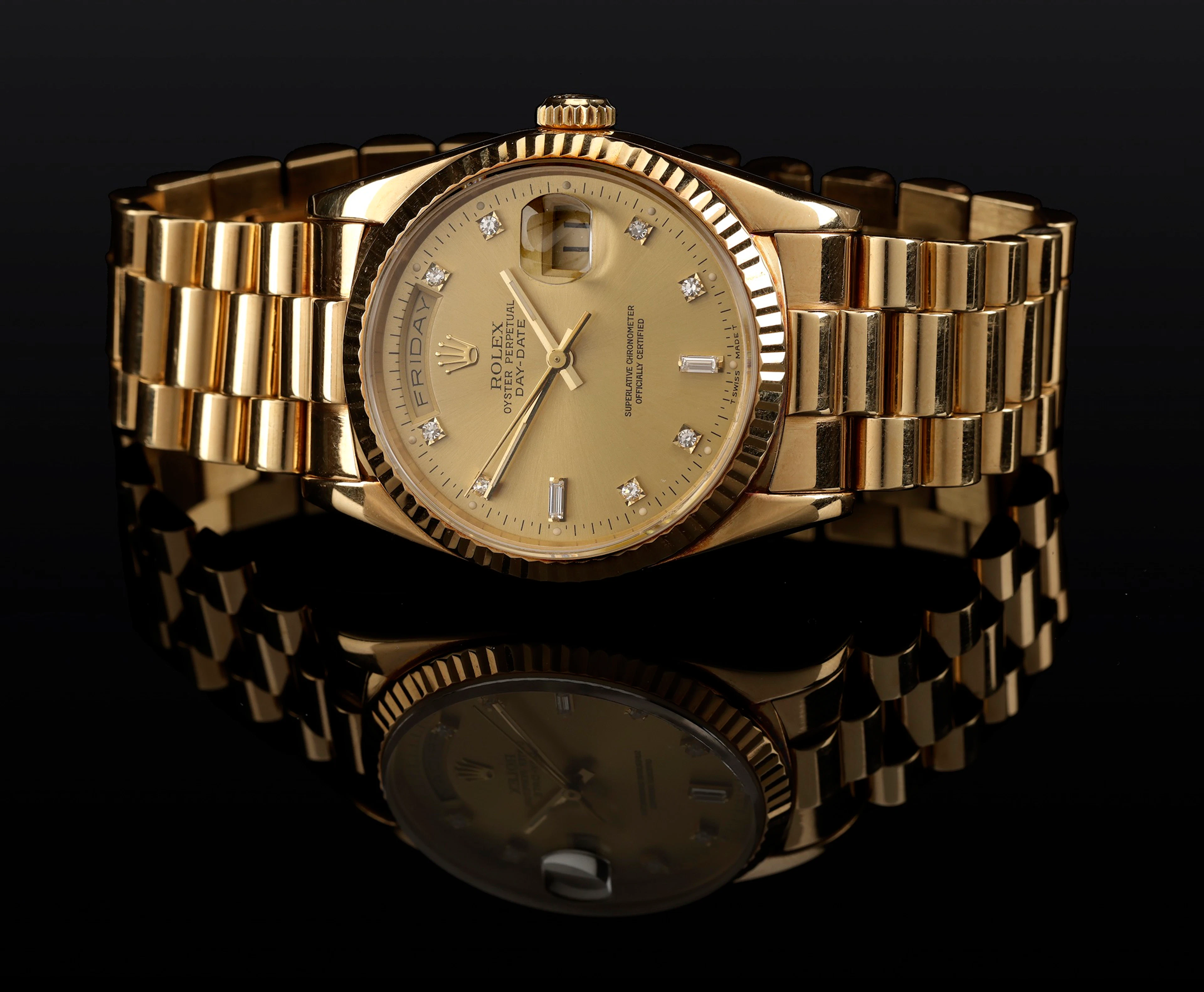 Rolex. A gold and diamond-set automatic wristwatch with day, date