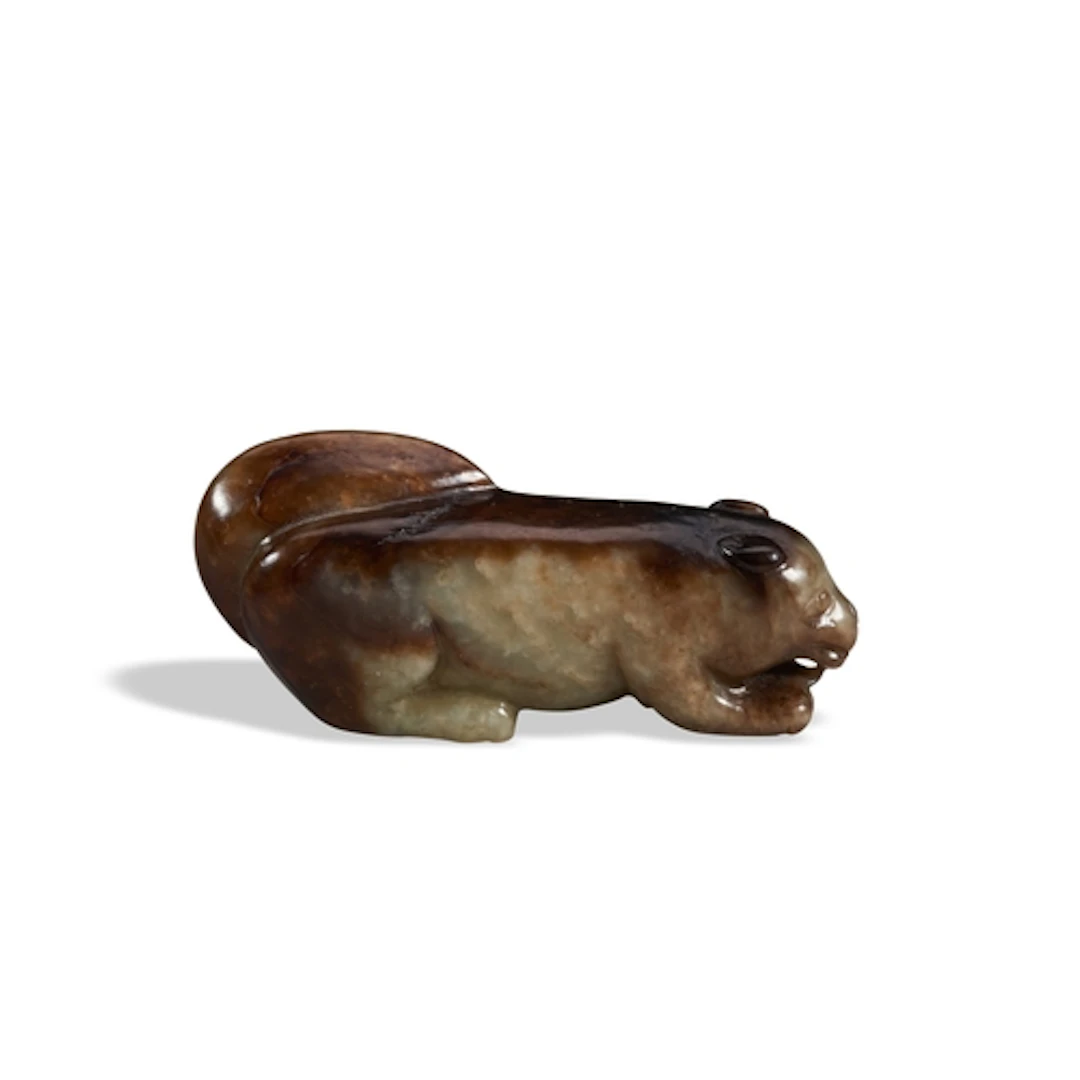 A MOTTLED BROWN-BLACK JADE FIGURE OF A SQUIRREL 17TH / 18TH ...