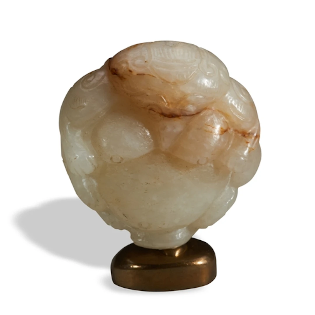 A CELADON AND RUSSET JADE 'GARUDA' PENDANT QING DYNASTY, 18...