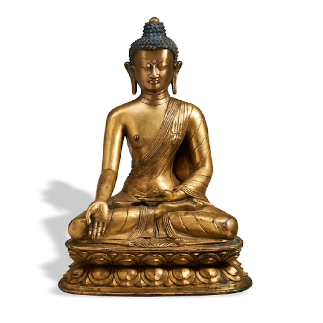 A SEATED GILT-BRONZE FIGURE OF SHAKYAMUNI BUDDHA SINO-TIBETA...