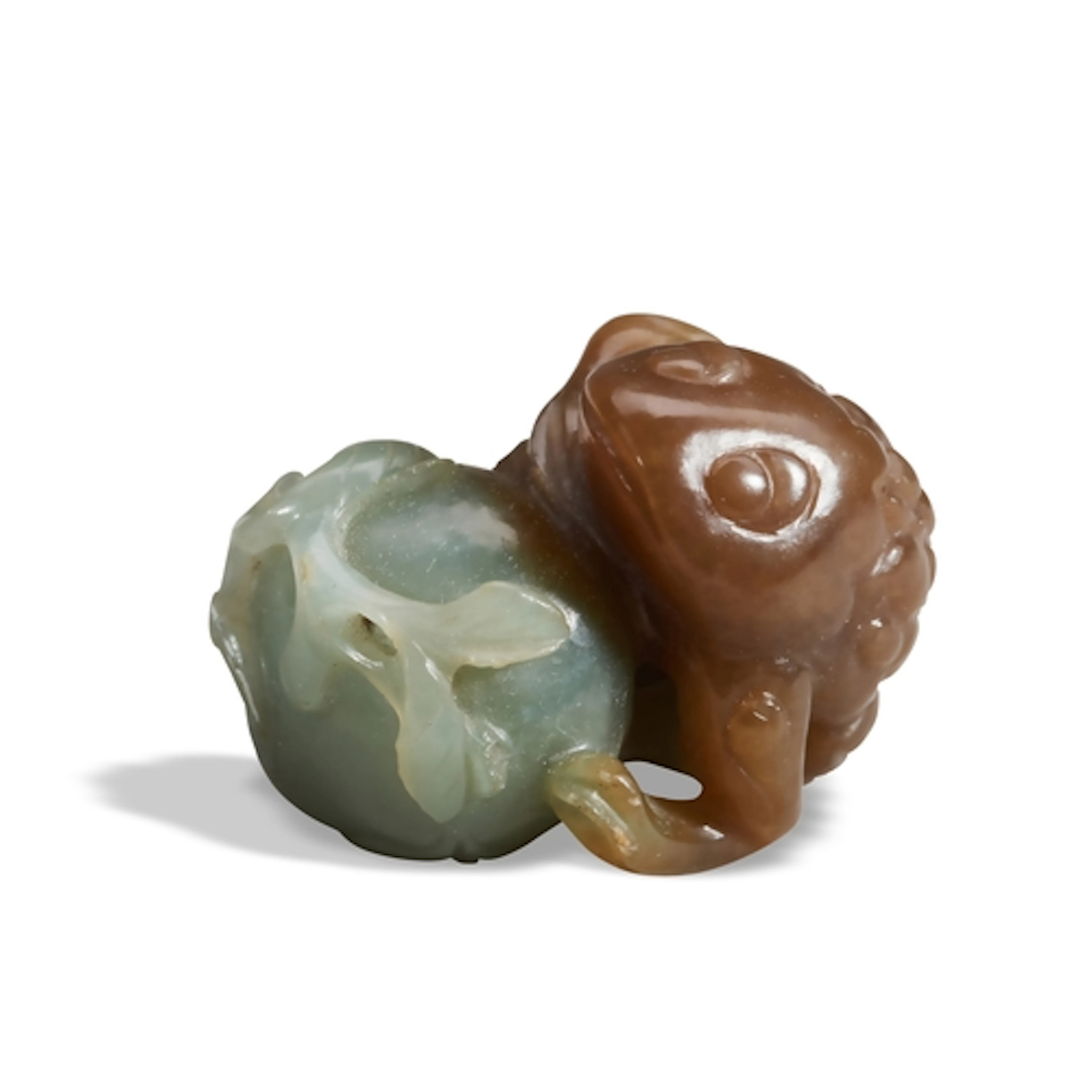 A BROWN AND CELADON JADE 'TOAD AND POMEGRANATE' GROUP QING D...