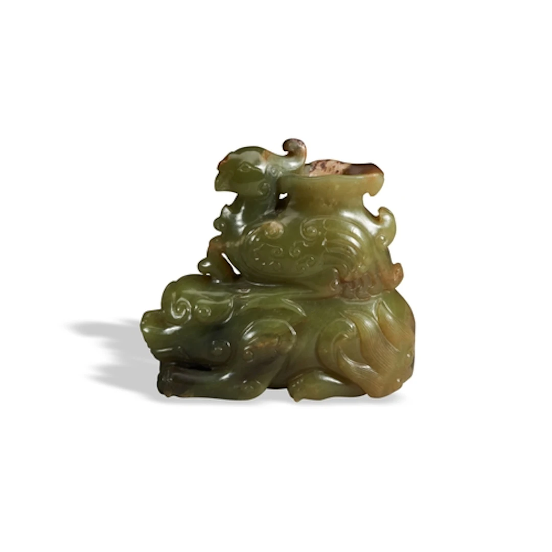 A YELLOW AND RUSSET JADE ARCHAISTIC 'LION AND PHOENIX' VASE ...