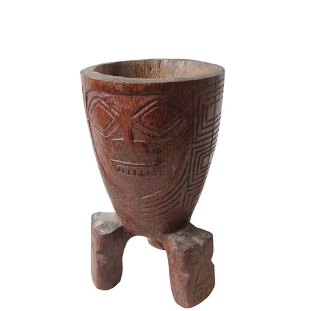 AN OCEANIC PALM WOOD MORTAR or possibly drum with two stylis...