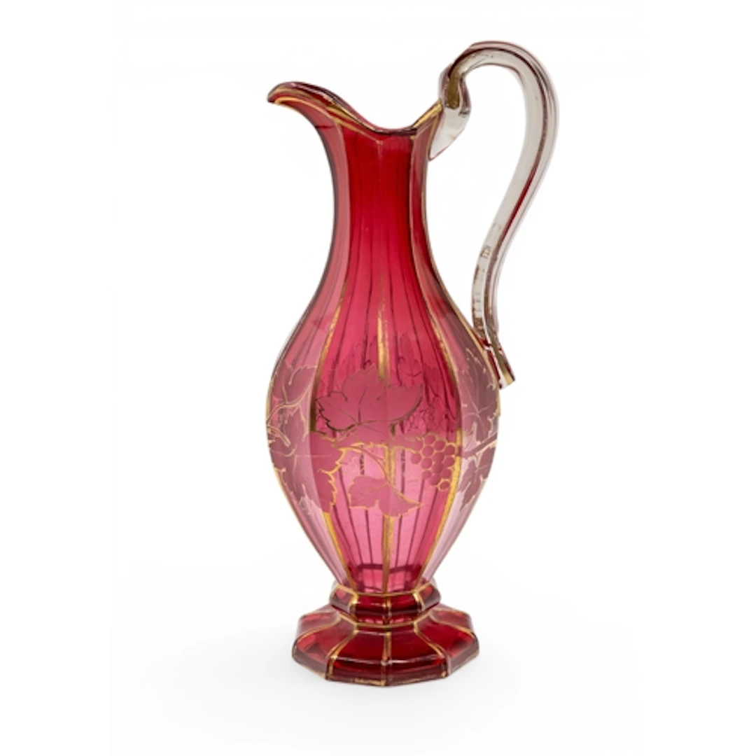 A BOHEMIAN CRANBERRY GLASS EWER faceted decagonal form, deco...