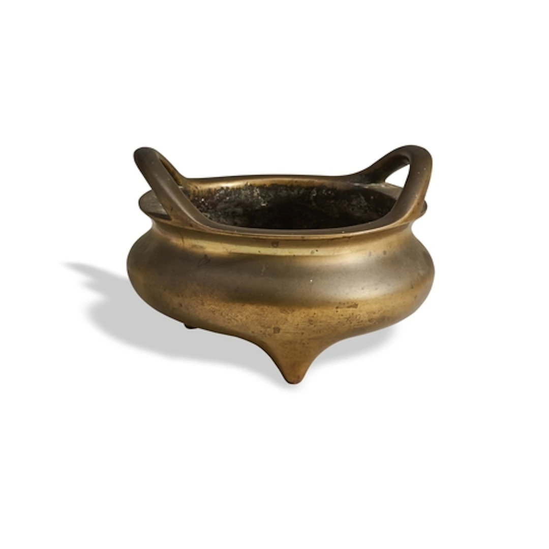 A BRONZE TRIPOD CENSER 17TH / 18TH CENTURY the compressed g...