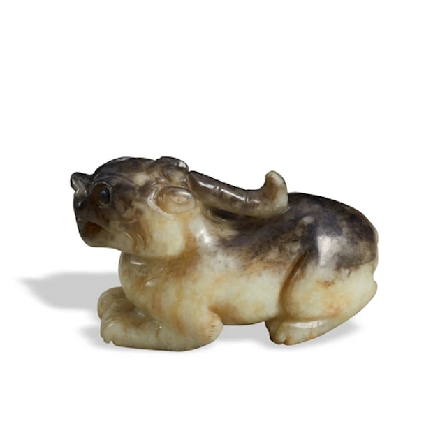A GREEN AND BLACK JADE MYTHICAL BEAST QING DYNASTY, 19TH CEN...