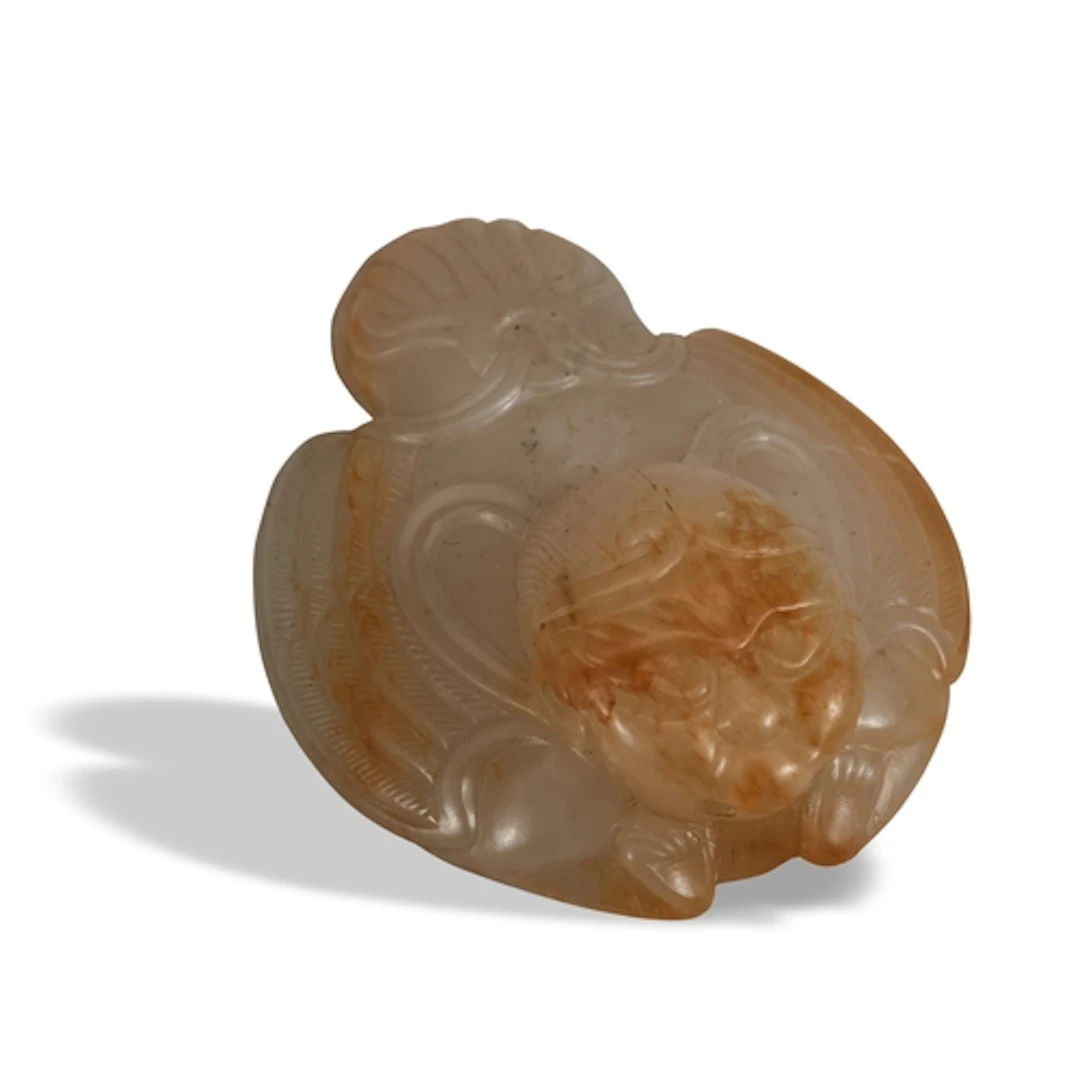 A WHITE AND RUSSET JADE GARUDA WITH DIADEM HAT ORNAMENT MING...