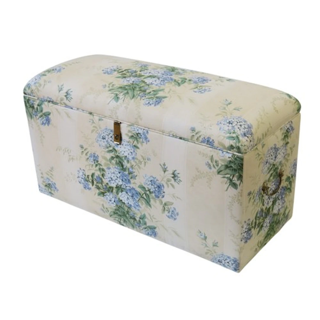 A VINTAGE OTTOMAN covered in a chintz material 50 x 92 x 39 ...