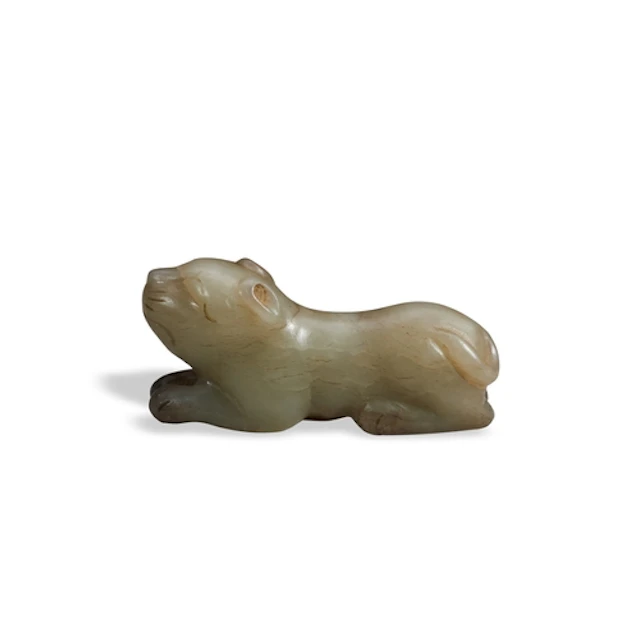 A MOTTLED GREYISH-GREEN JADE FIGURE OF A FELINE QING DYNASTY...