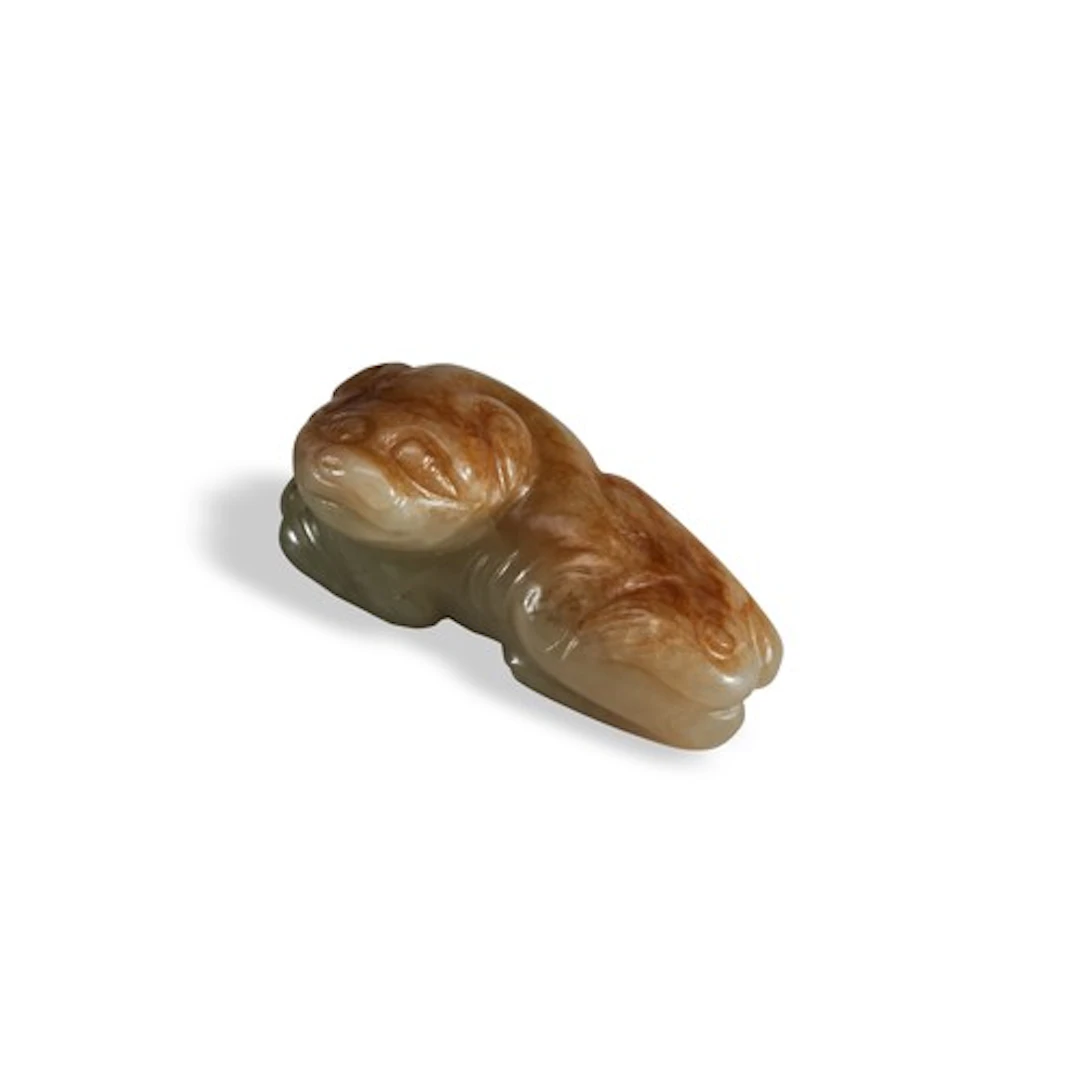 A CELADON AND RUSSET JADE FIGURE OF A HOUND MING DYNASTY (13...