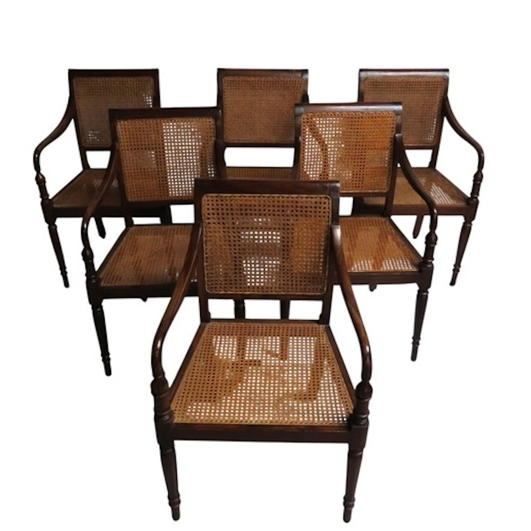 A SET OF SIX 'COLONIAL' STYLE OPEN DINING ARMCHAIRS, the tea...