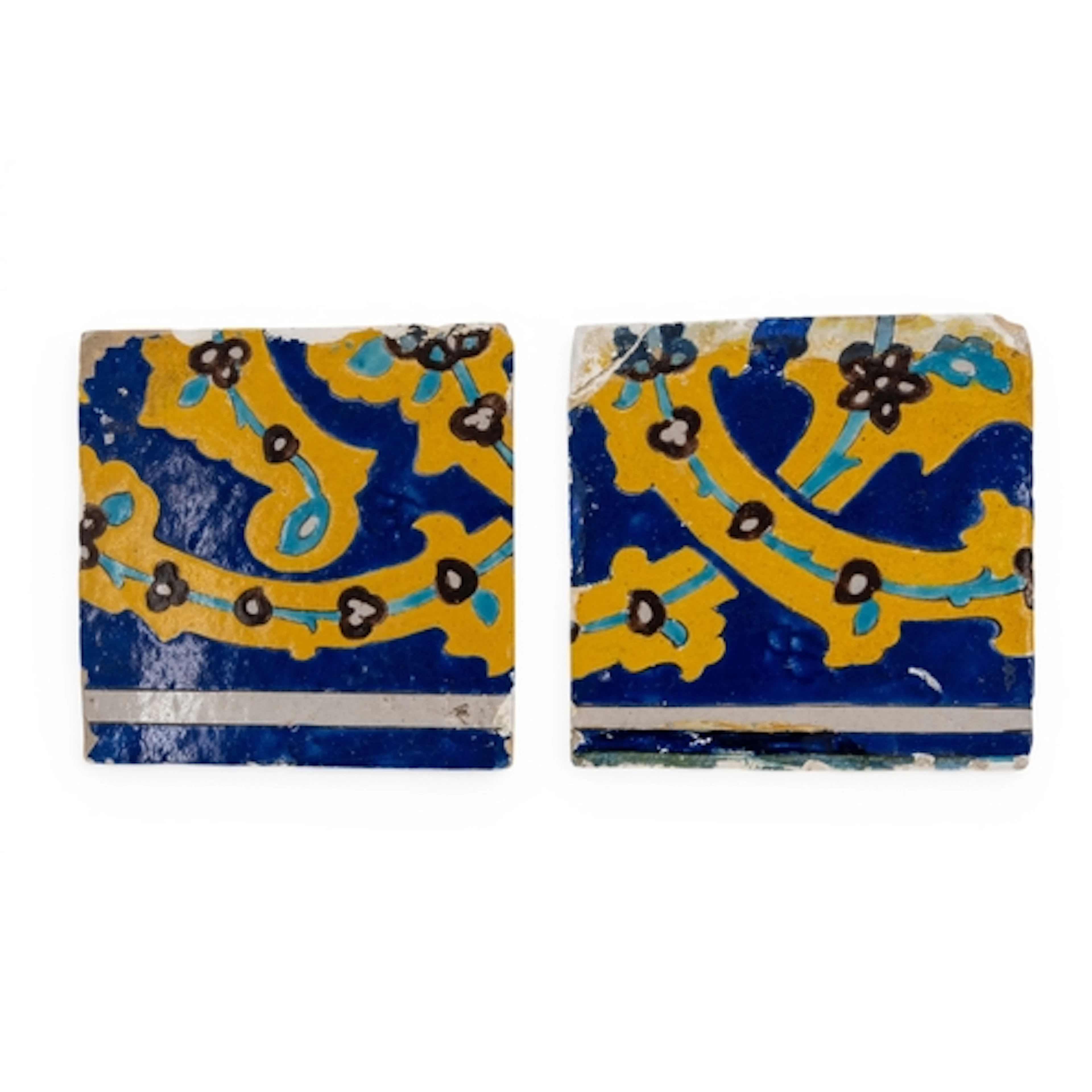 A PERSIAN FRIEZE TILE with blue ground and yellow strapwork ...