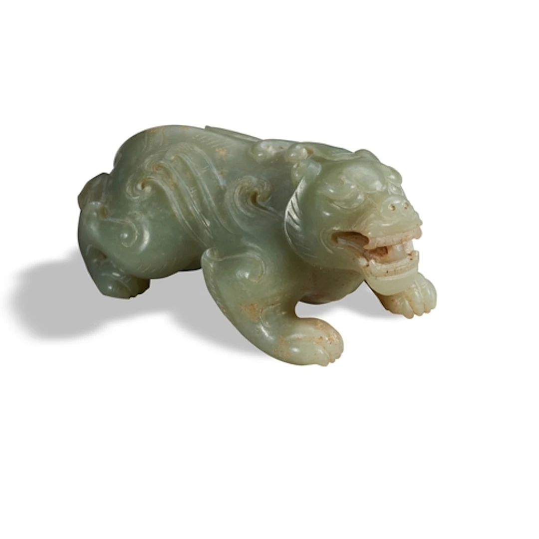A CELADON JADE FIGURE OF A MYTHICAL BEAST, 20TH CENTURY 青白玉兽...