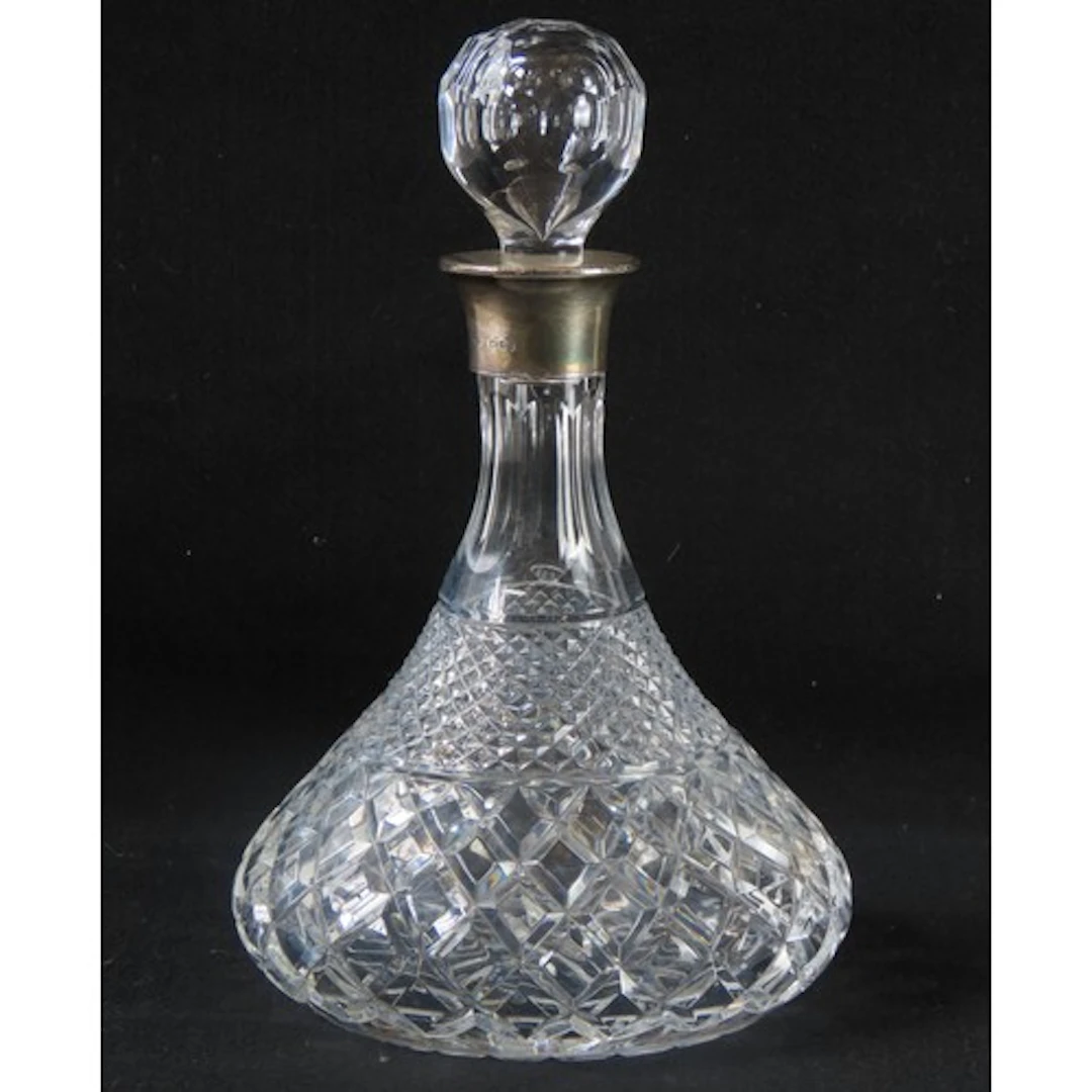 A SILVER MOUNTED SHIP'S DECANTER with faceted globular stop...