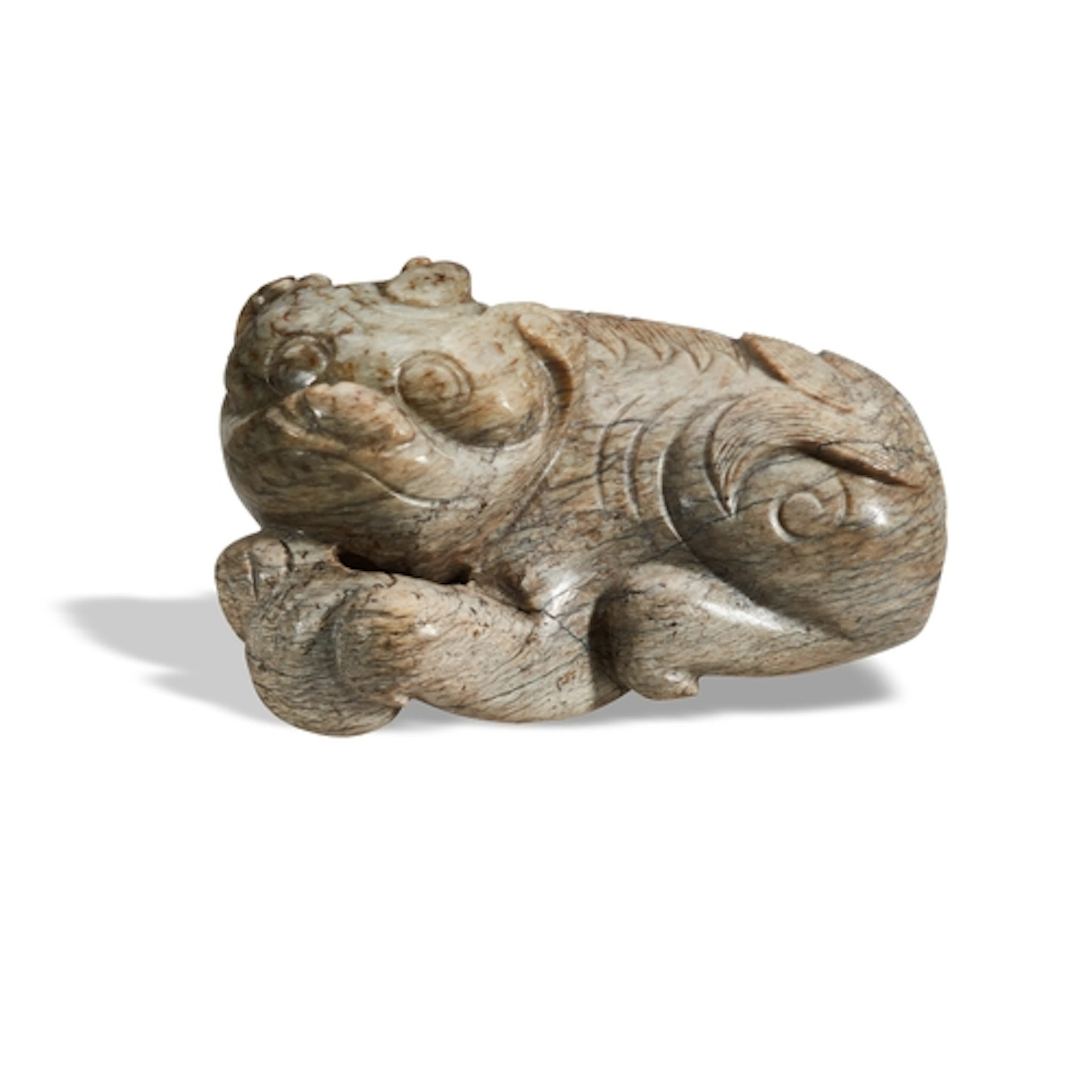 AN ARCHAISTIC CALCIFIED JADE FIGURE OF A LION MING DYNASTY O...