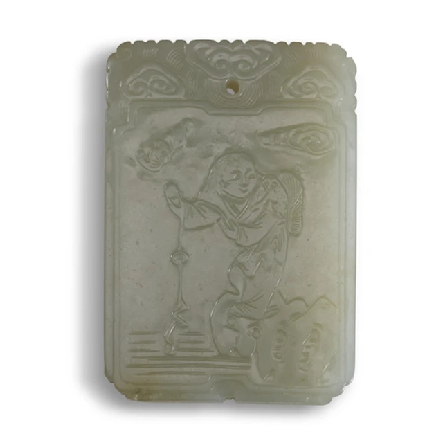 A CELADON JADE PLAQUE CARVED WITH LIU HAI AND THE THREE-LEGG...