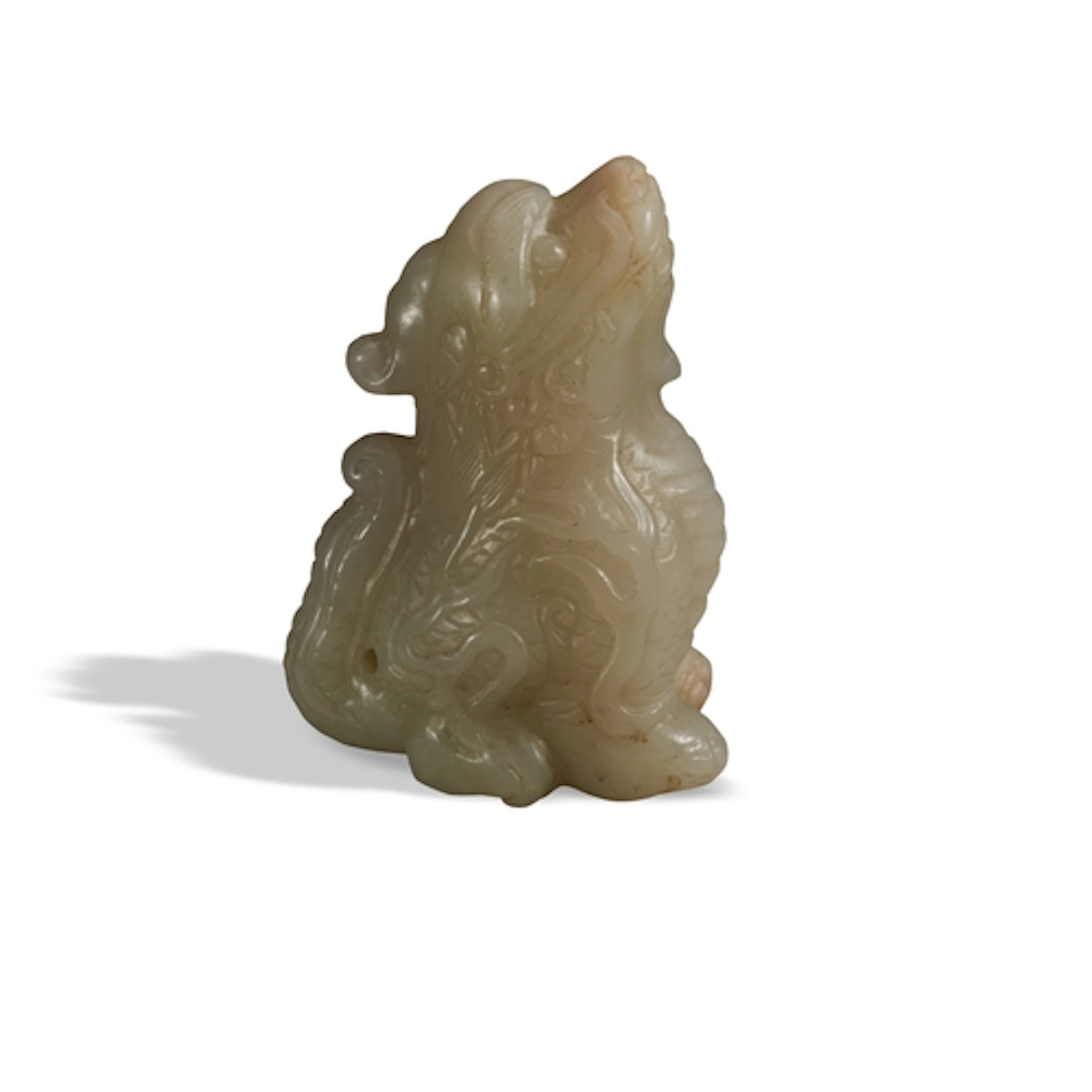 A MOTTLED CELADON JADE FIGURE OF A MYTHICAL BEAST QING DYNA...