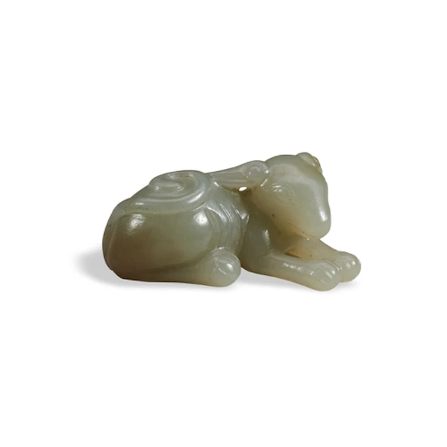 A PALE-CELADON JADE FIGURE OF A DOG 17TH / 18TH CENTURY 青灰玉...