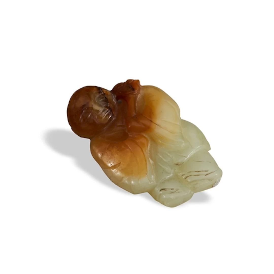 A CELADON AND RUSSET JADE FIGURE OF A BOY QING DYNASTY, 19TH...