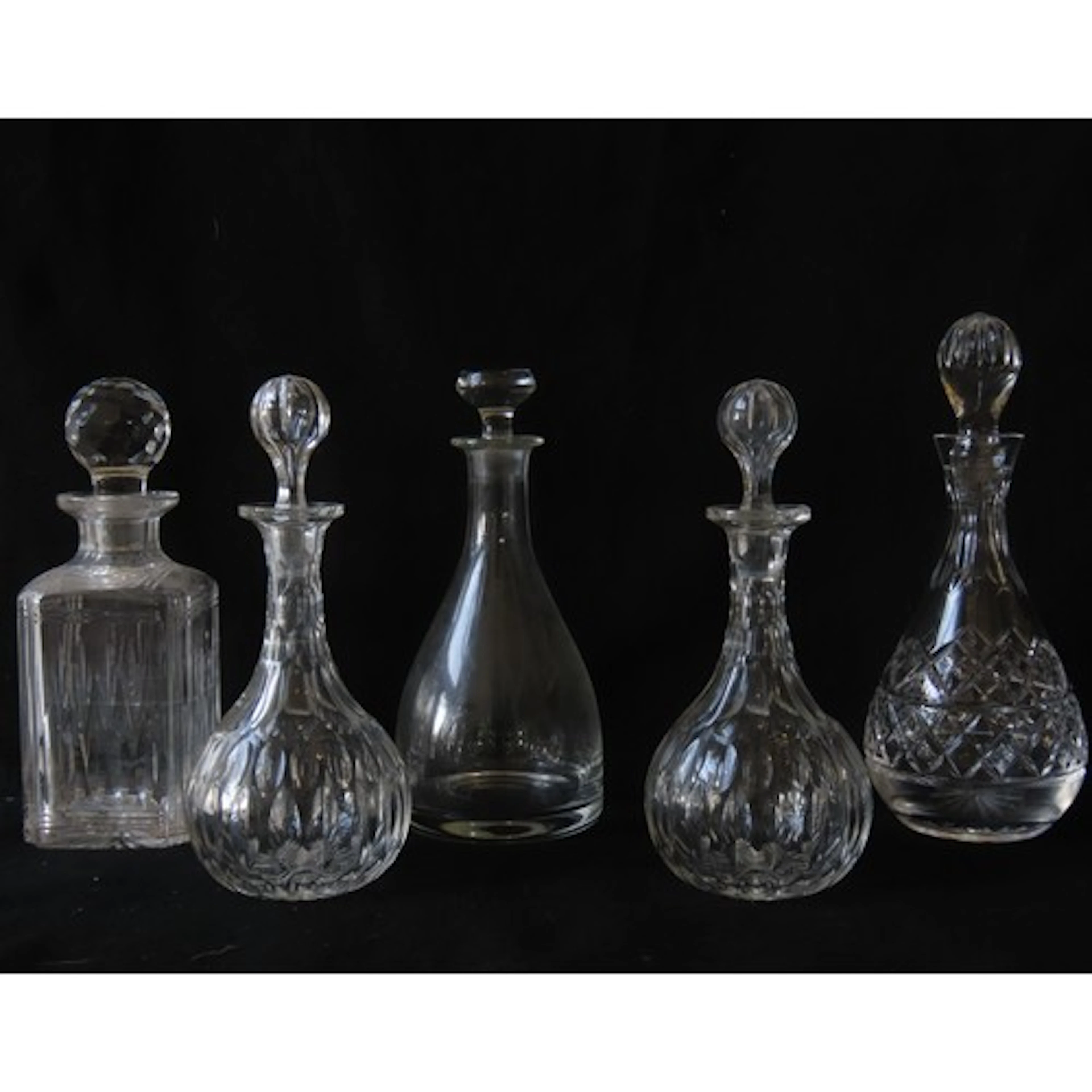 A PAIR OF EDWARDIAN CUT GLASS DECANTERS with globular stoppe...