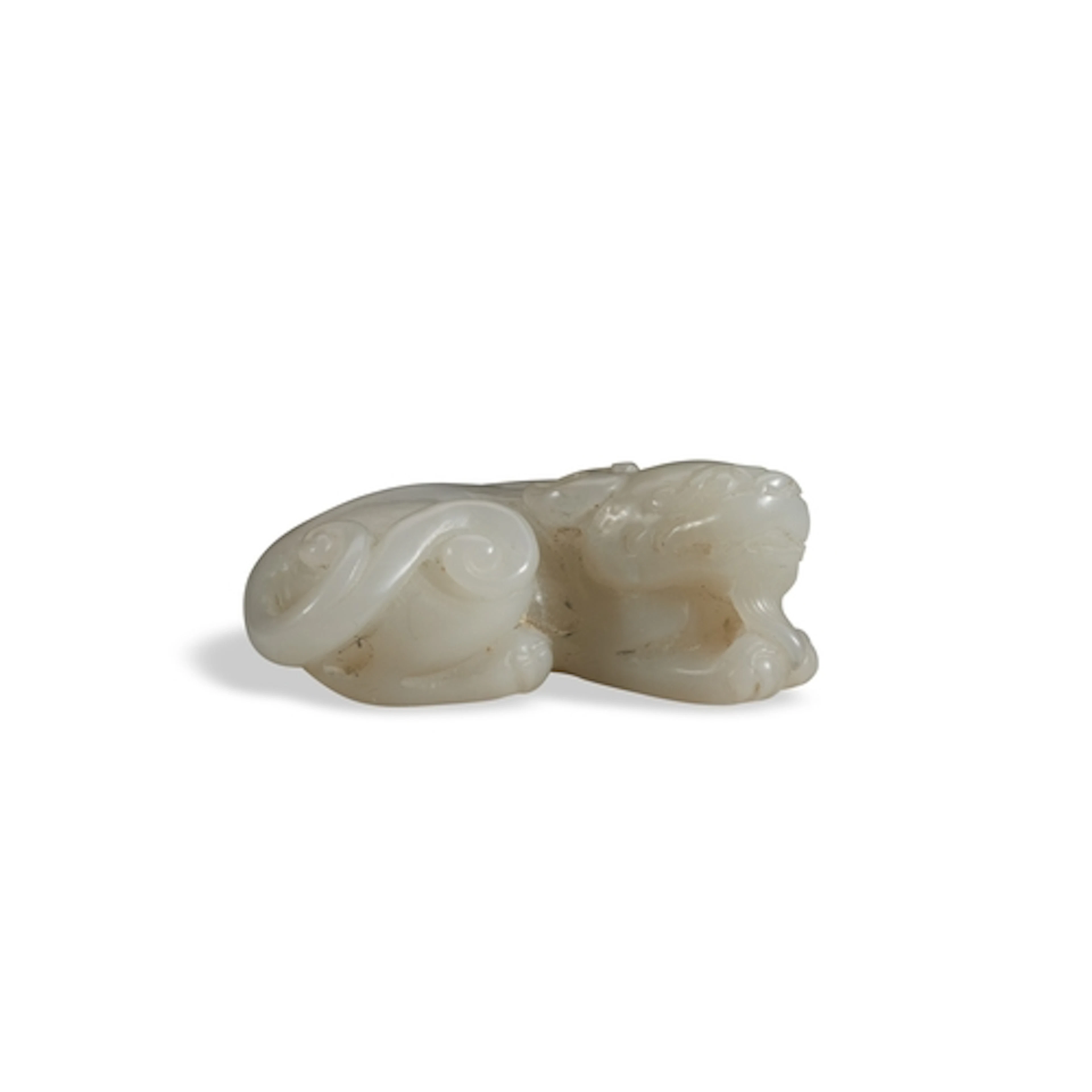 A WHITE JADE FIGURE OF A LION QING DYNASTY, 19TH CENTURY 白玉狮...