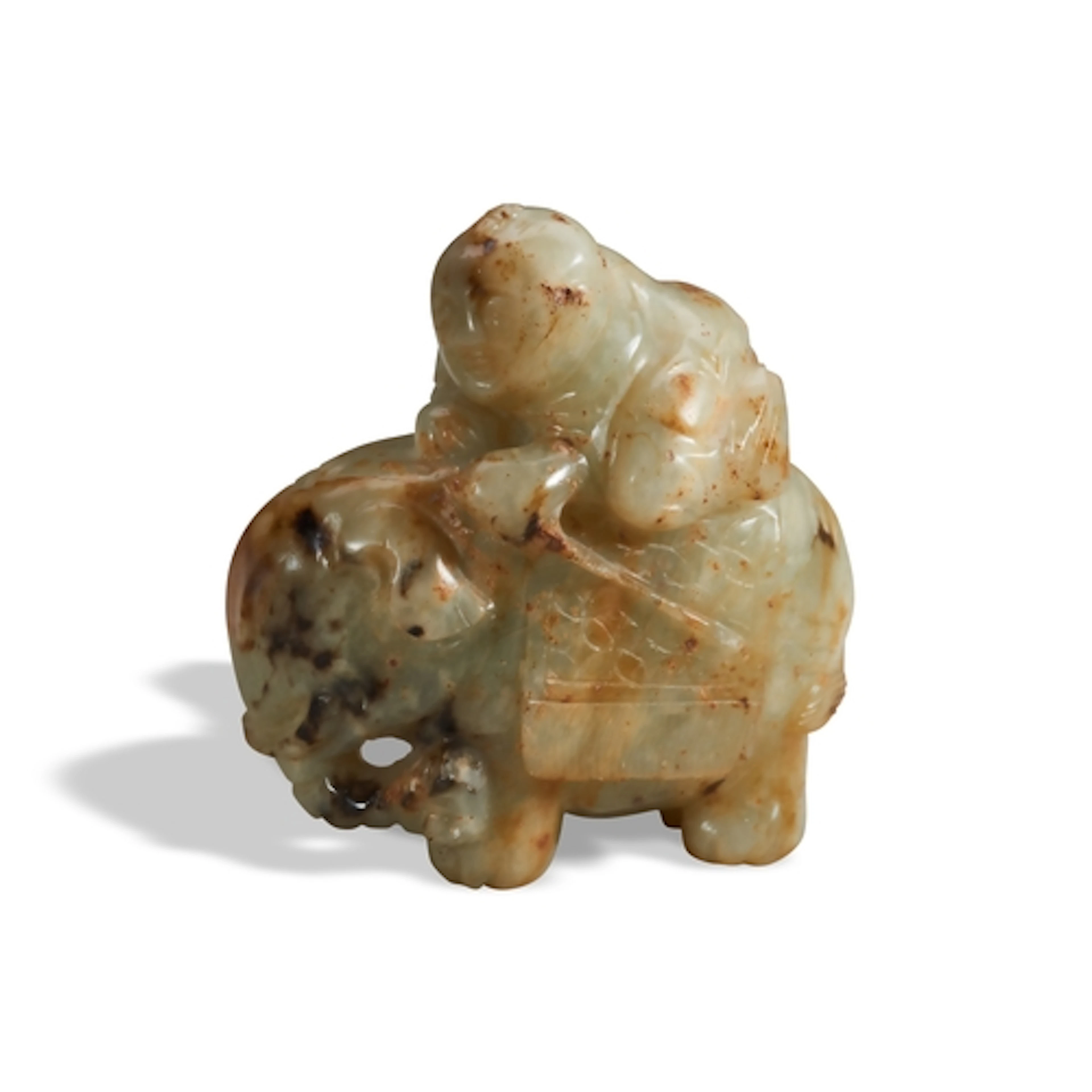 A MOTTLED RUSSET CELADON JADE GROUP OF A BOY ON ELEPHANT QIN...