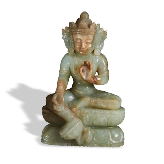 A CELADON AND RUSSET JADE FIGURE OF BUDDHA 19TH / 20TH CENT...