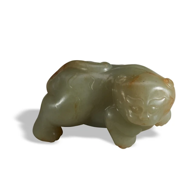 A CELADON AND RUSSET JADE ARCHAIC-STYLE LION QING DYNASTY, 1...
