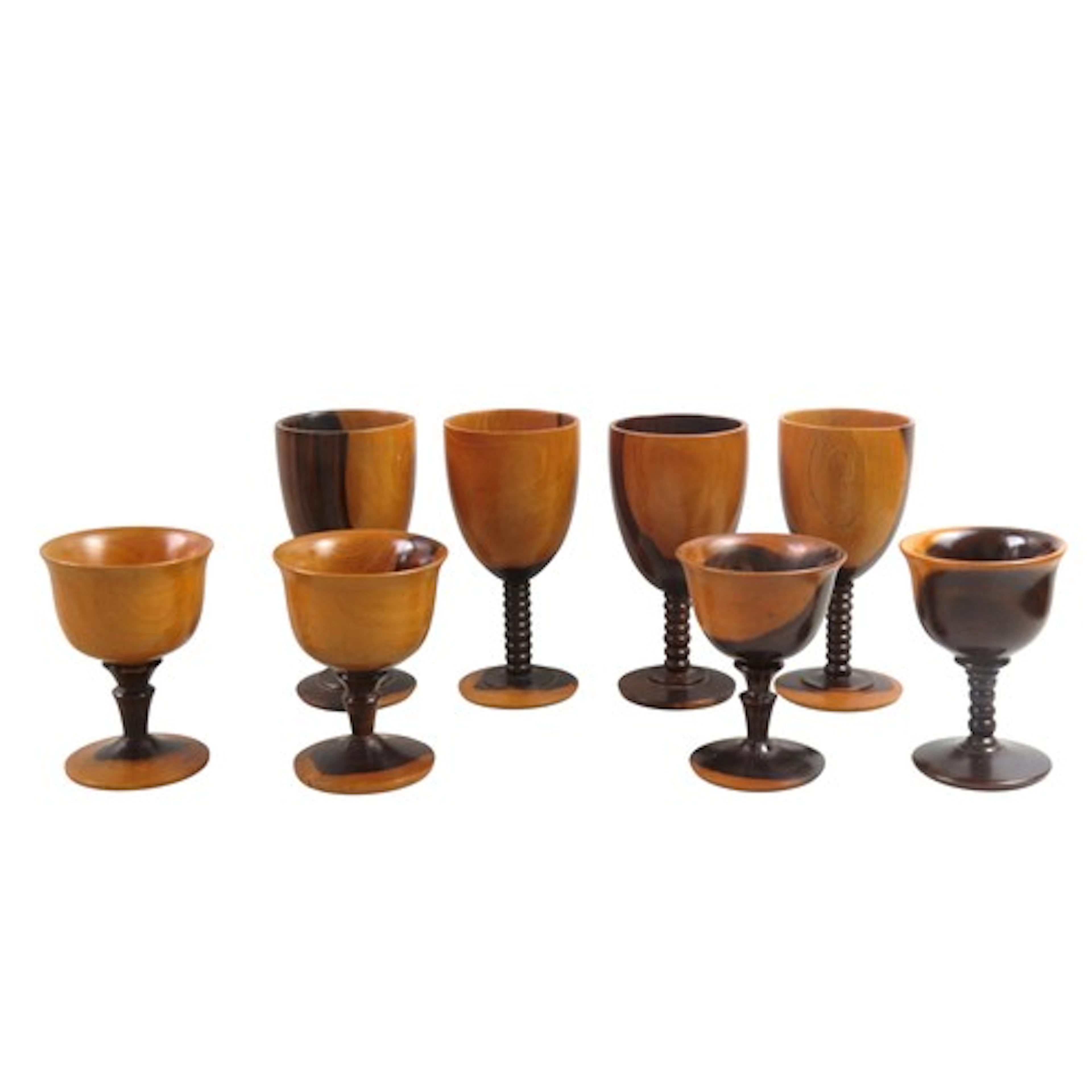 A SET OF FOUR LIGNUM VITAE GOBLETS with bobbin turned stems,...