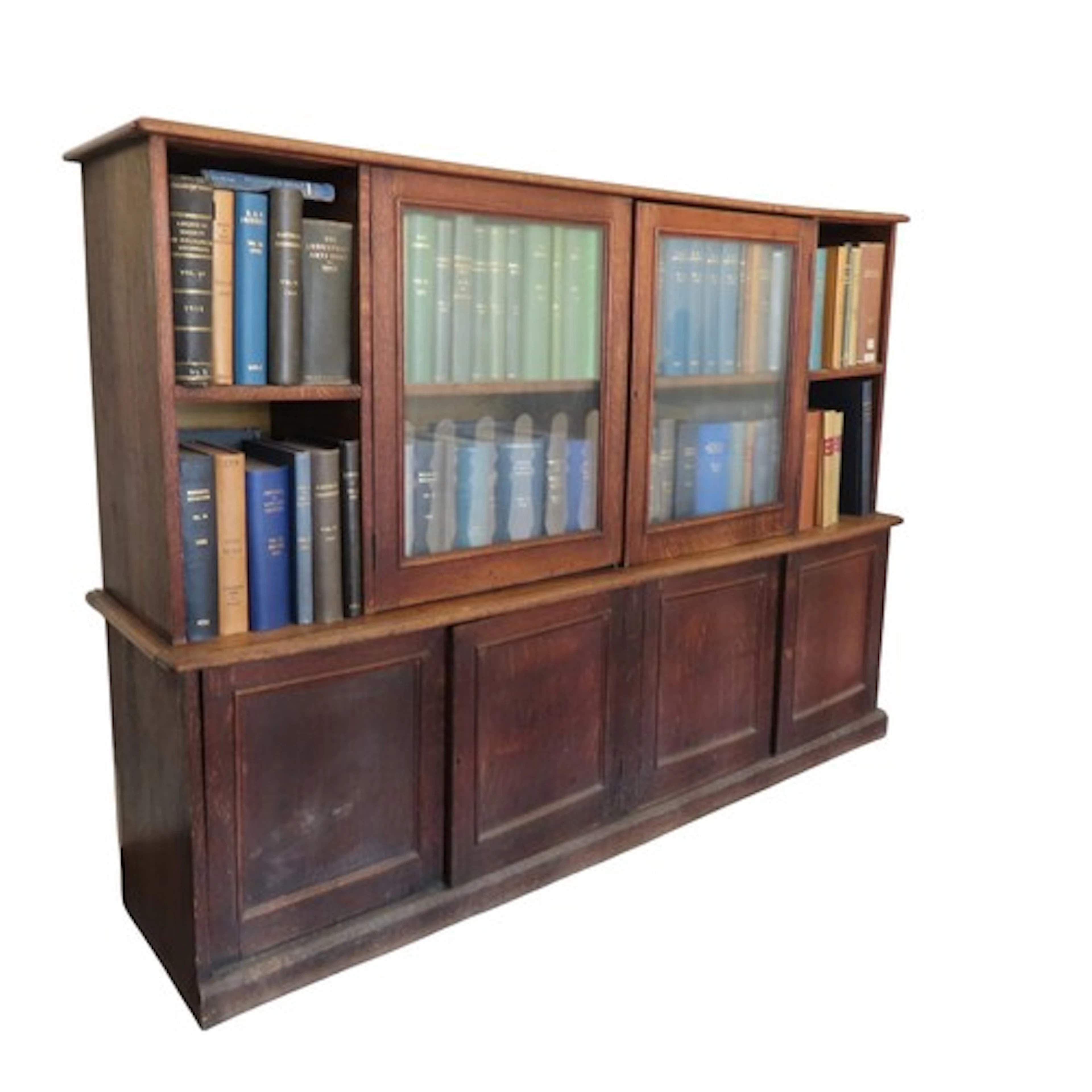 A VINTAGE OAK BOOKCASE ON CUPBOARD EARLY 20TH CENTURY with t...