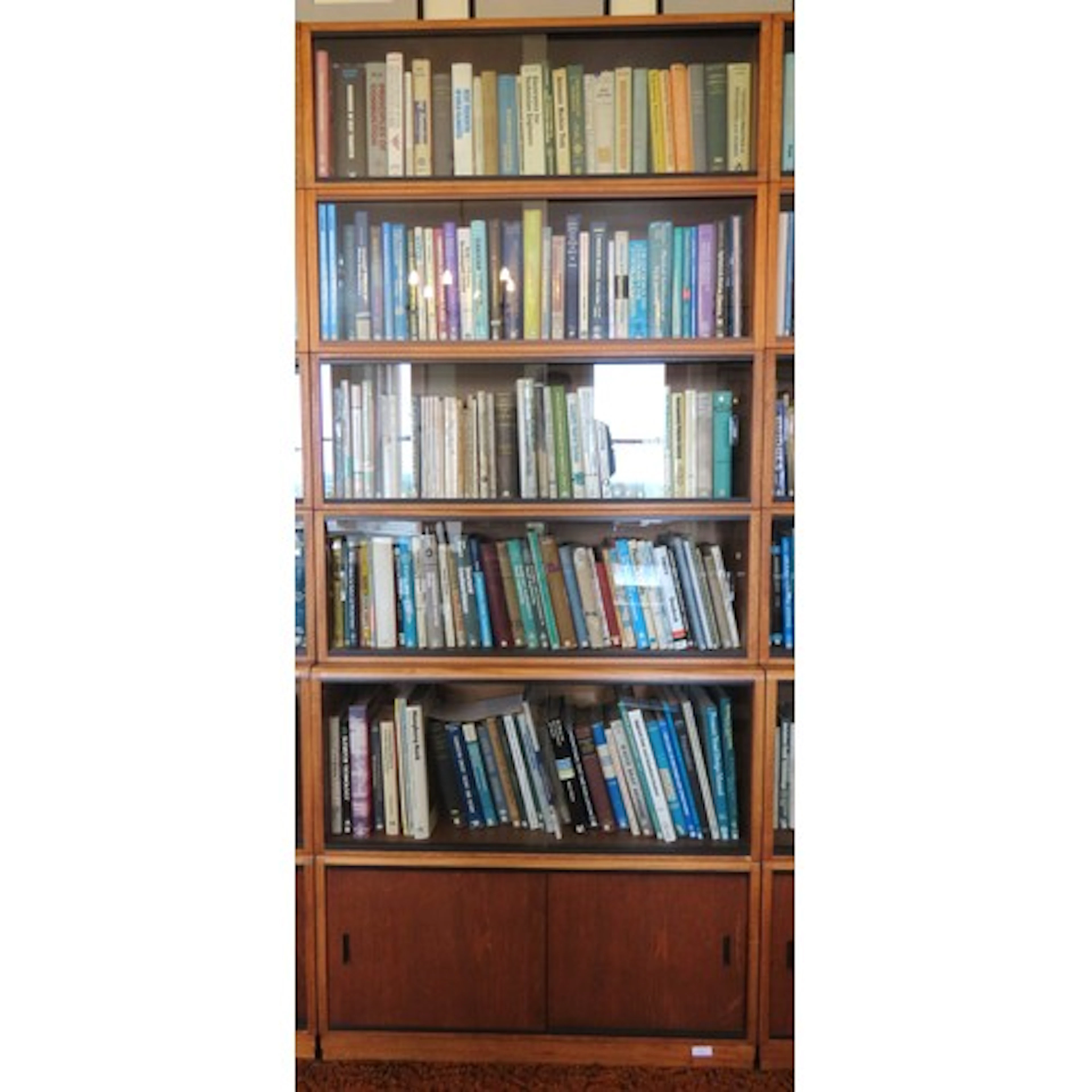A SIMPLEX SECTIONAL LIBRARY BOOKCASE CIRCA 1965 comprised of...