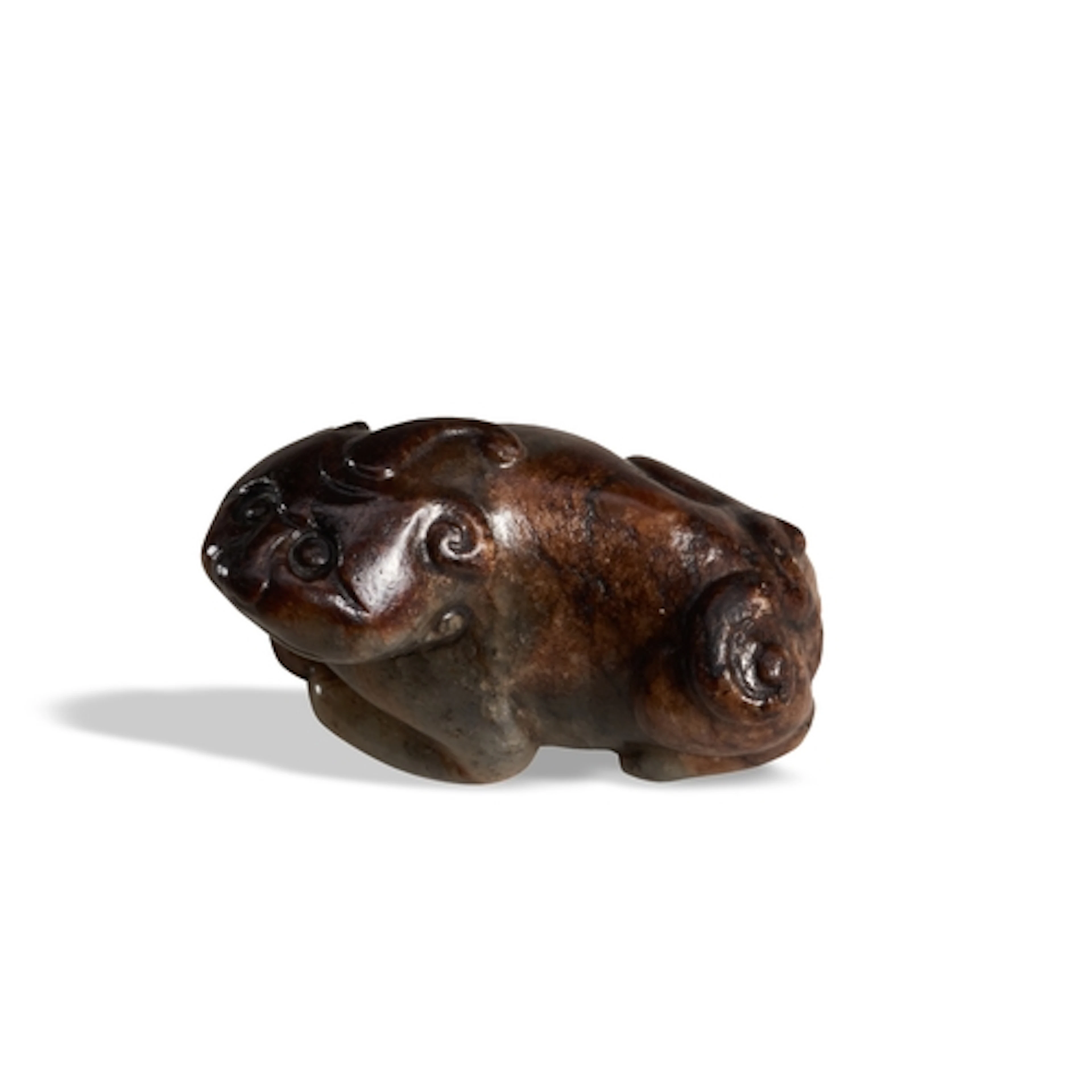 A MOTTLED-GREYISH JADE FIGURE OF A HORNED CHIMERA 17TH / 18T...
