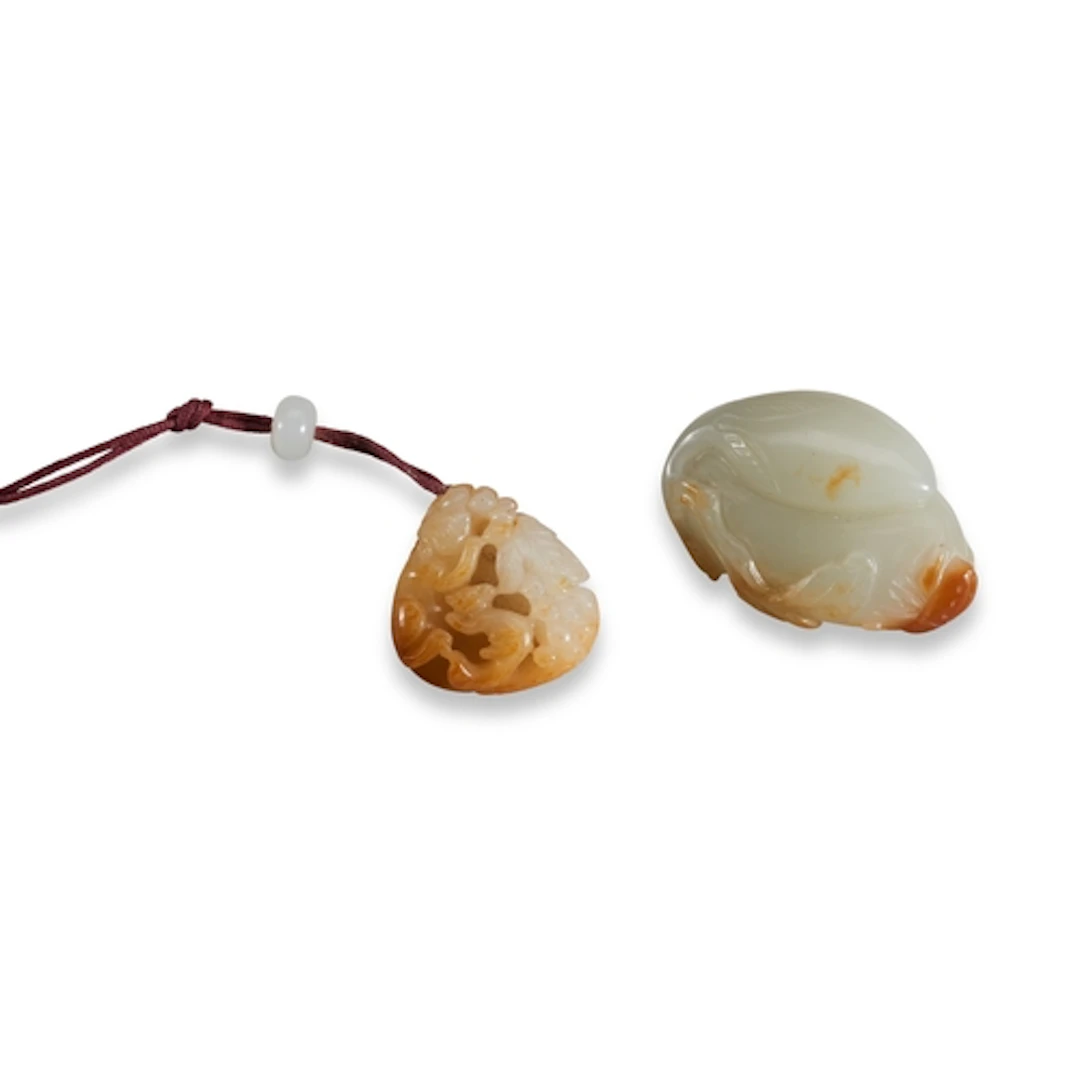 TWO WHITE AND RUSSET JADE PENDANTS QING DYNASTY (1644-1911)...