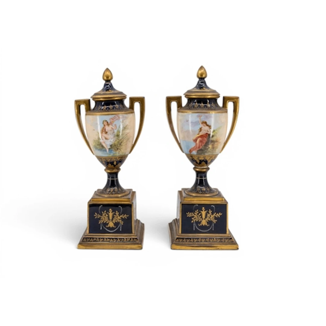 A PAIR OF VIENNA PORCELAIN VASES, the urns hand painted with...
