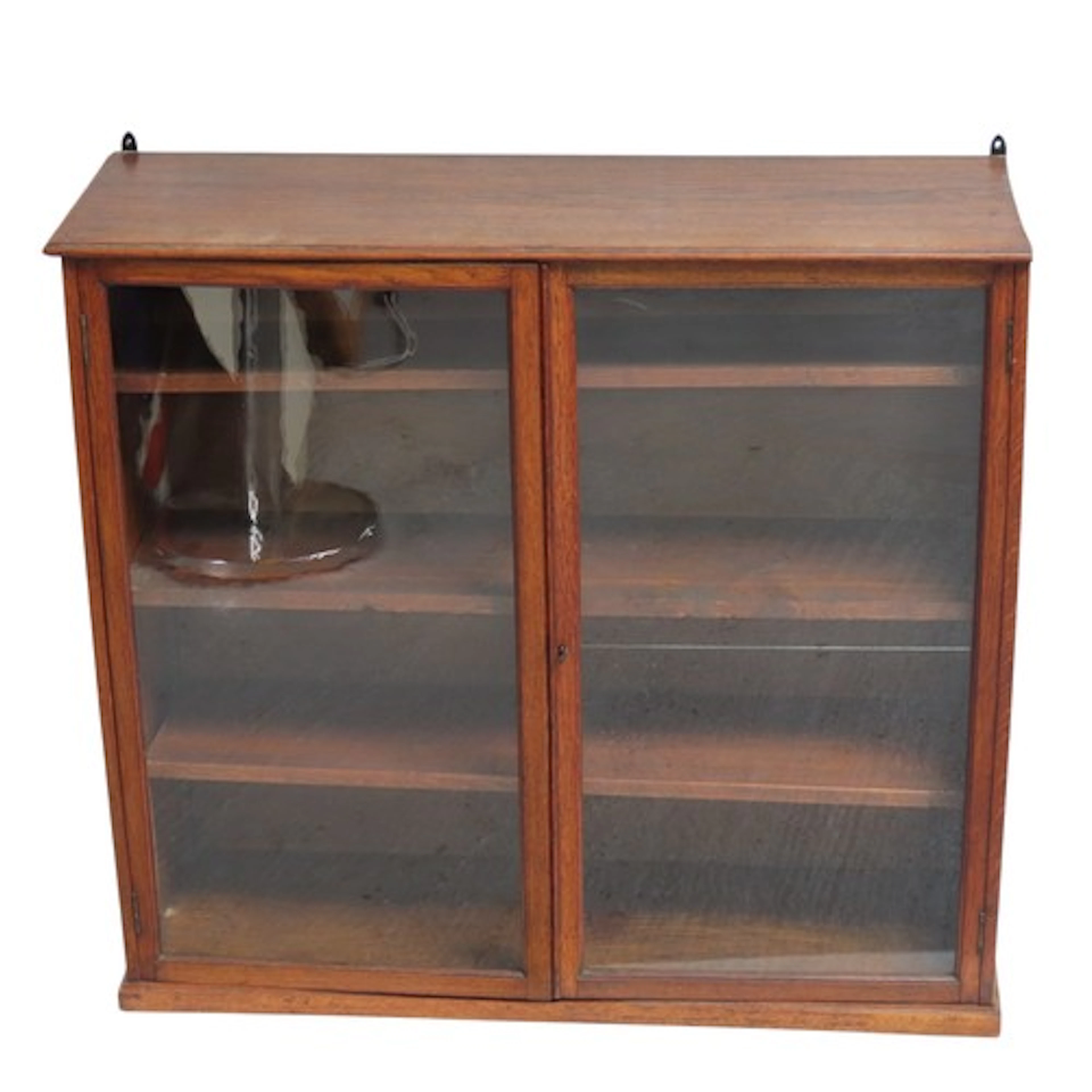 A VINTAGE OAK BOOKCASE the two glazed cabinet doors enclosin...