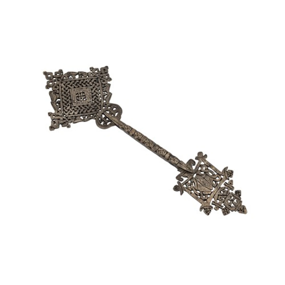 A COPTIC ALLOY RETICULATED CROSS, hand-held and pierced with...