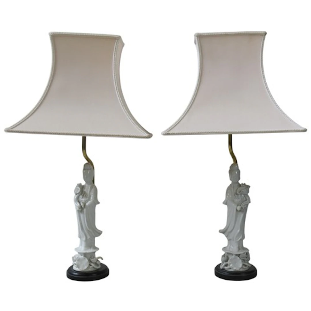 A PAIR OF FIGURAL BLANC DE CHINE TABLE LAMPS modelled as Gua...