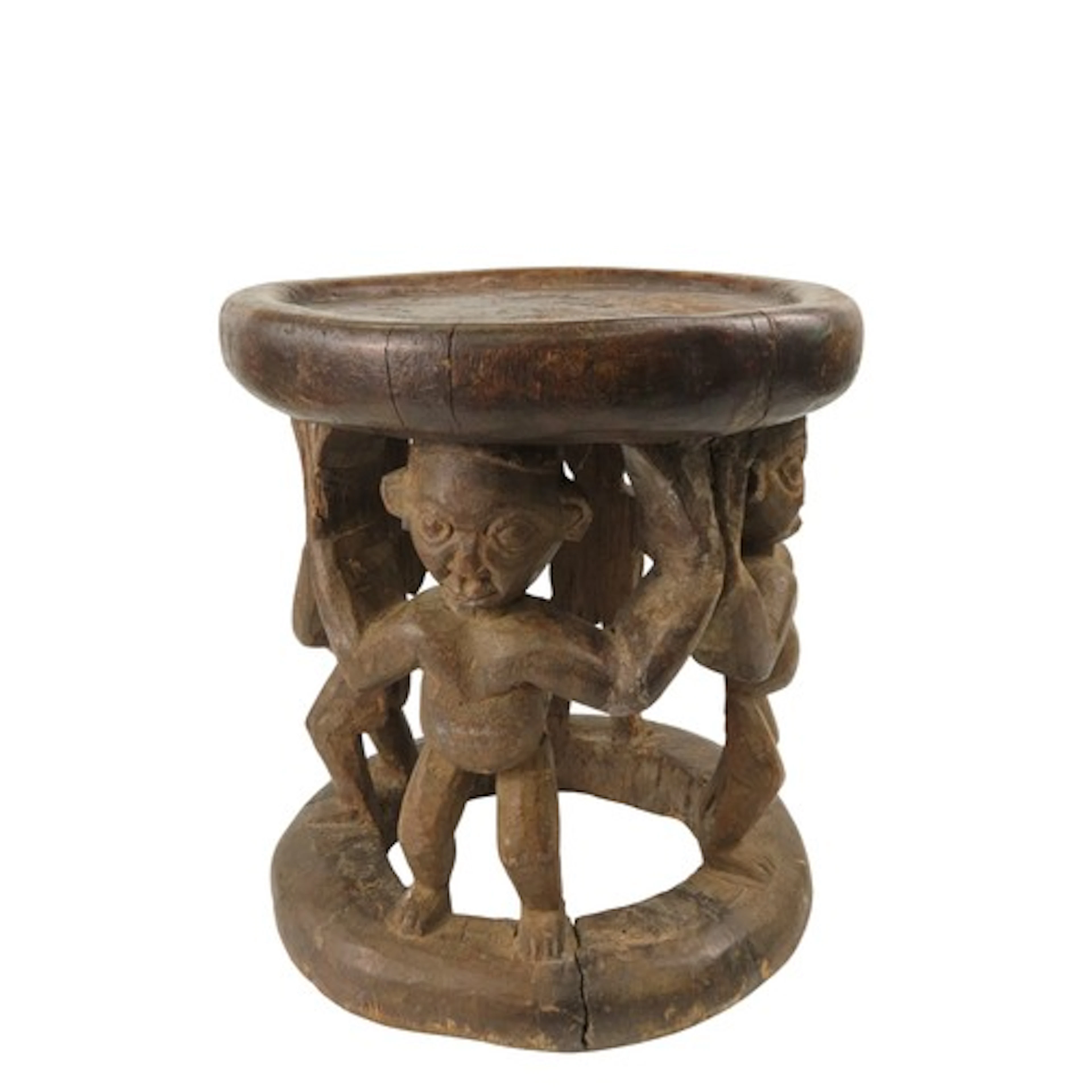 A BAMILEKE CARVED WOODEN STOOL, the top supported by four an...