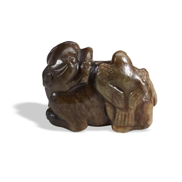 A BLACK AND GREEN JADE 'LION AND BIRD' GROUP 19TH / 20TH CE...