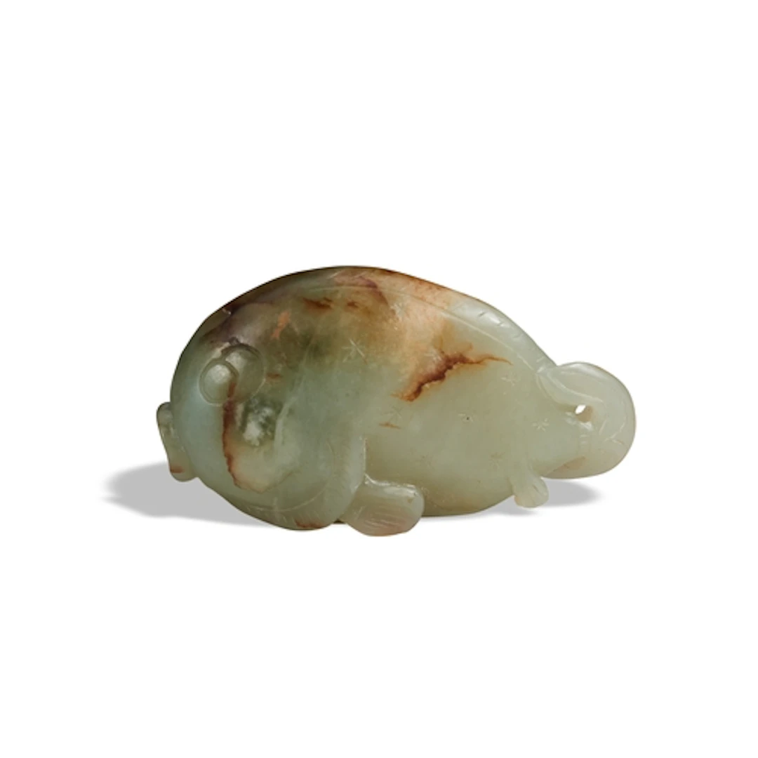 A CELADON RUSSET JADE CARVING OF A FISH QING DYNASTY, 19TH C...