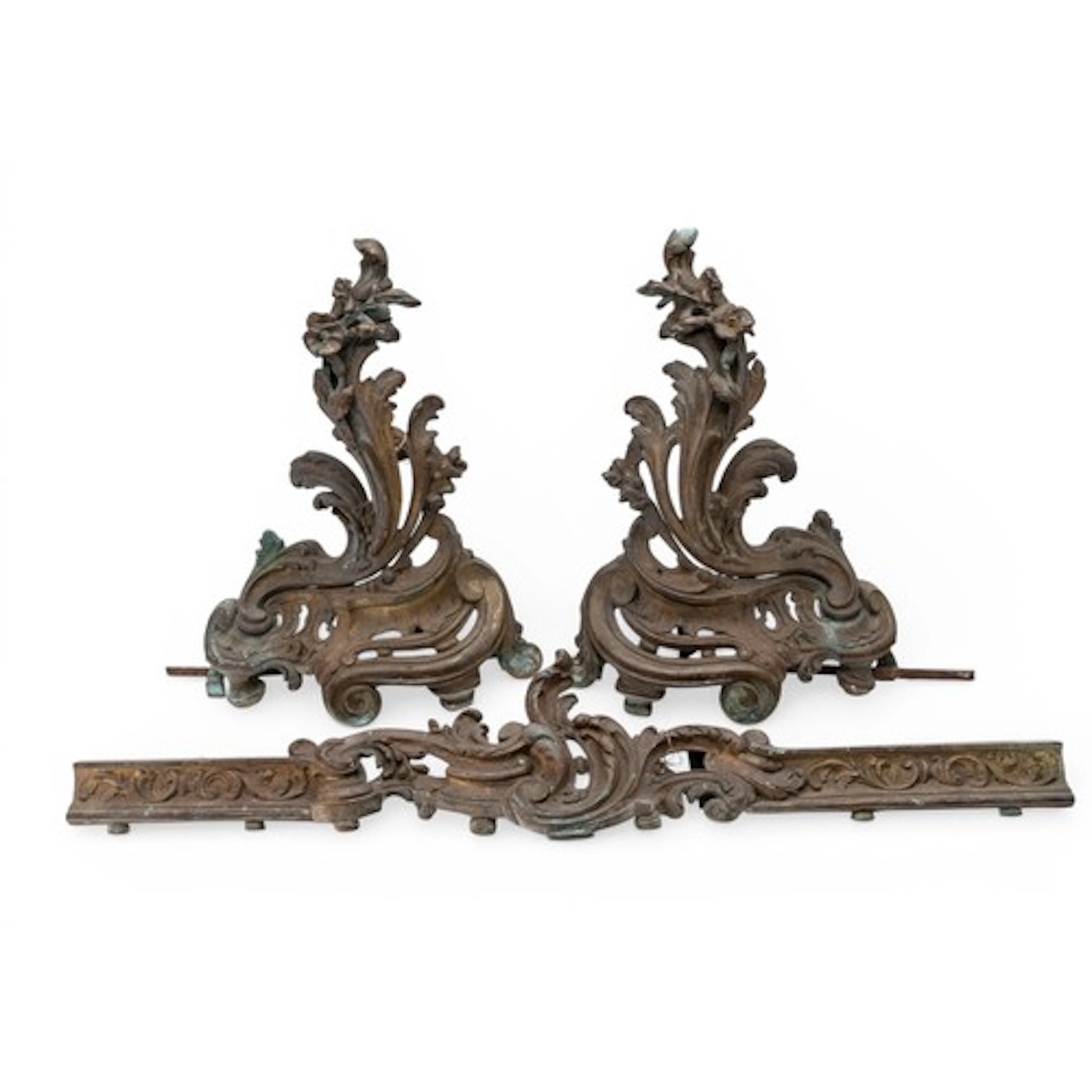 A PAIR OF ROCOCO STYLE BRASS CHENET AND CURB with ornate fol...