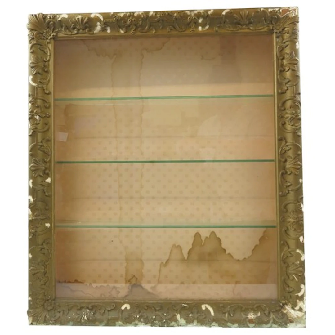 A VINTAGE WALL MOUNTED BIJOUTERIE CABINET the gilt gesso fra...