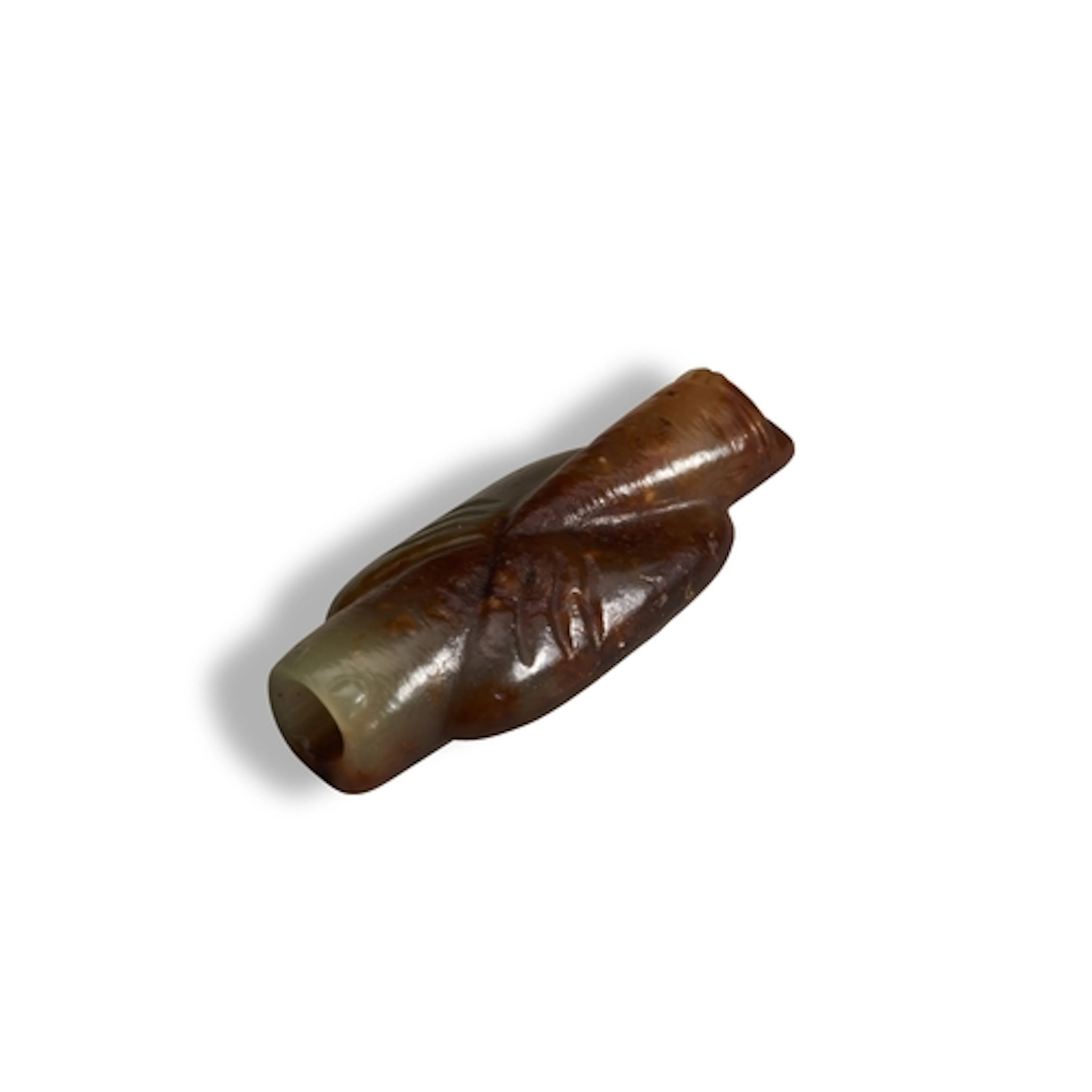 A CELADON AND RUSSET JADE ARCHAIC-STYLE PENDANT OF A BEARDED...
