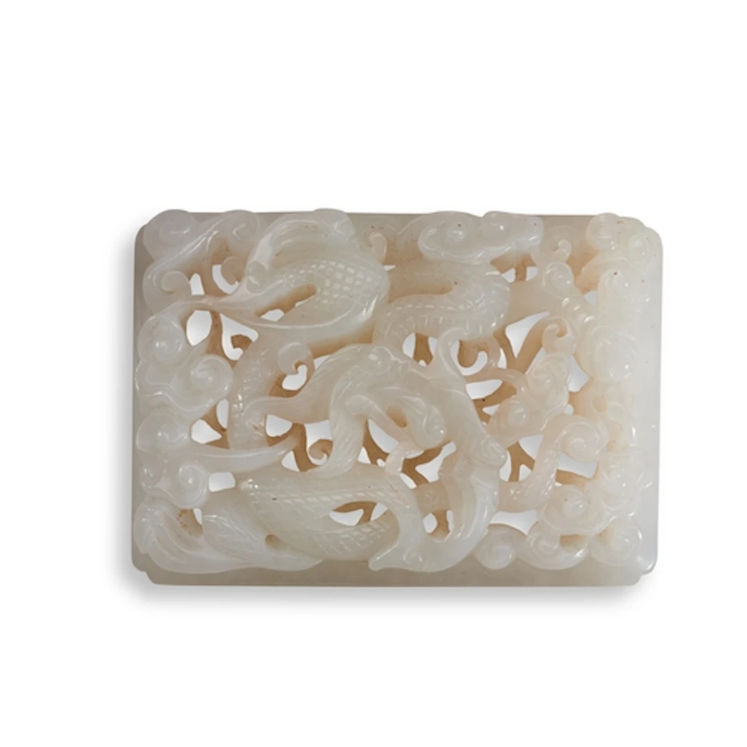 A JADE OPENWORK PLAQUE CARVED WITH DRAGONS, 20TH CENTURY 白玉龙...