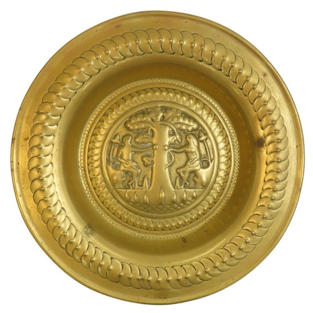 A NUREMBERG TYPE BRASS ADAM & EVE CHARGER or dish, proba...