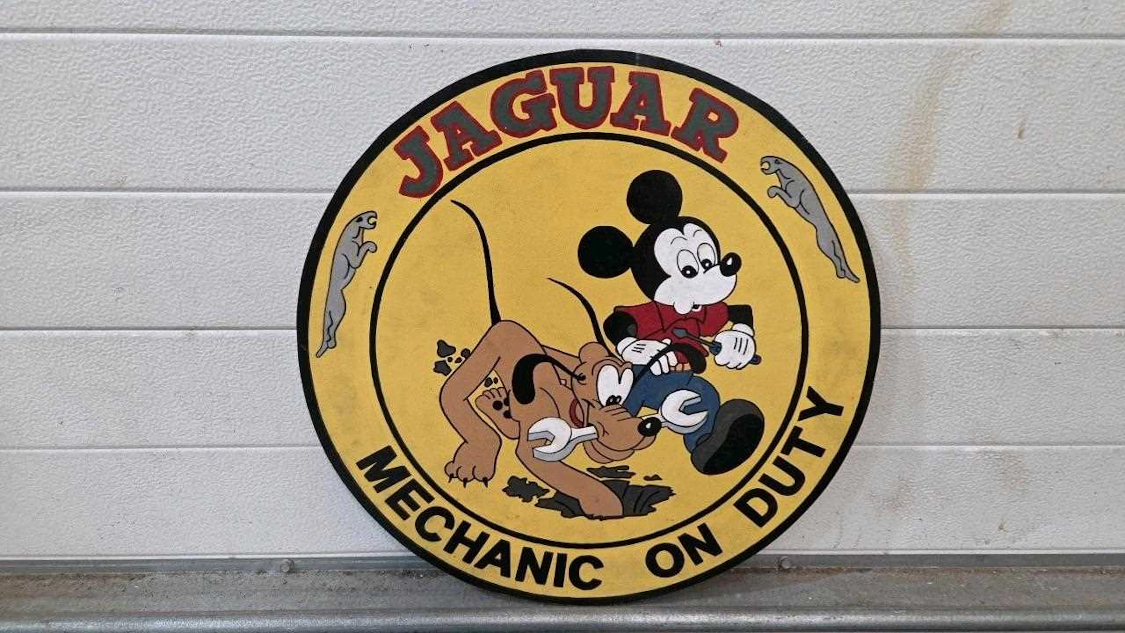 WOODEN HAND PAINTED, JAGUAR MECHANIC ON DUTY SIGN 20" DIA