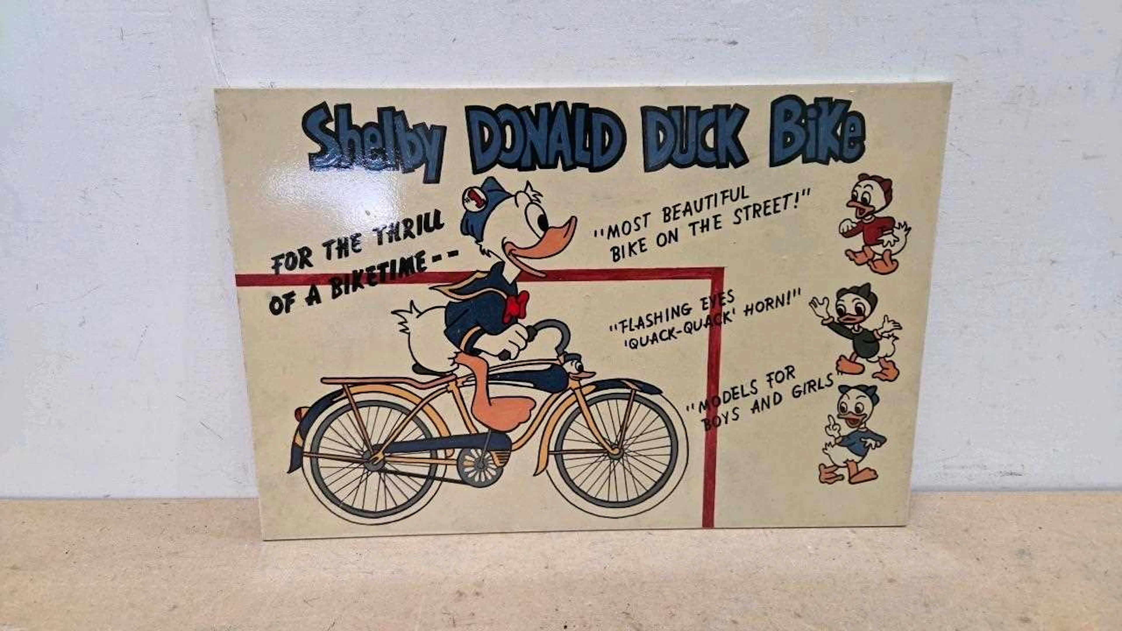 SHELBY DONALD DUCK BIKE, WOODEN HAND PAINTED SIGN 24" X 16"